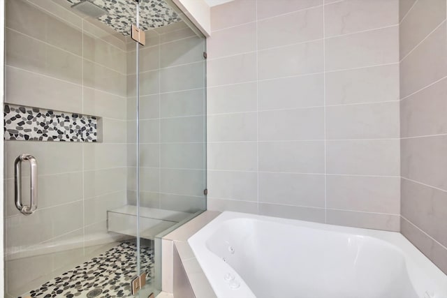 bathroom featuring separate shower and tub