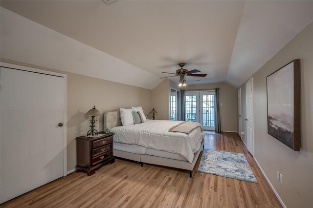 bedroom with access to outside, lofted ceiling, light wood-type flooring, and ceiling fan