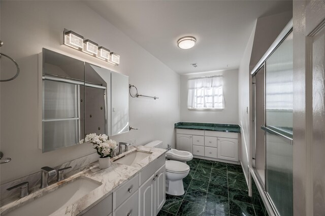 bathroom featuring toilet, walk in shower, vanity, and a bidet