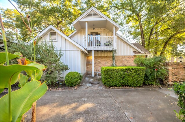 rear view of property featuring a balcony