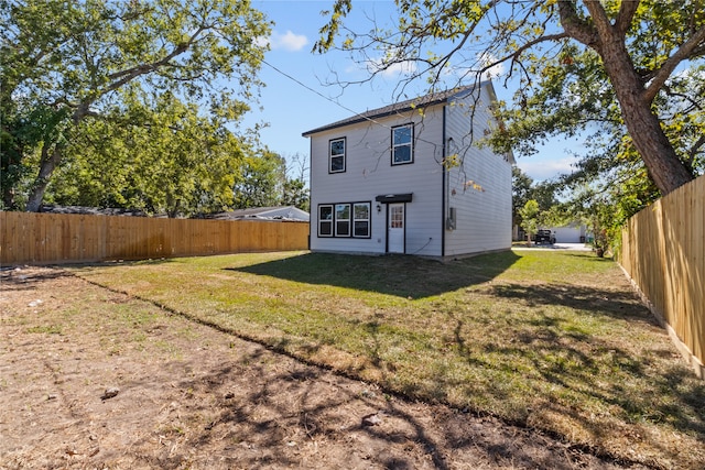 back of house featuring a yard