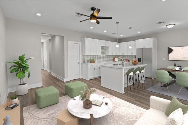 living room with ceiling fan, sink, and hardwood / wood-style floors