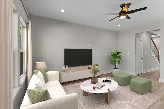 living room with hardwood / wood-style floors and ceiling fan