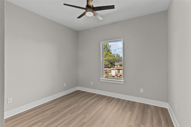 spare room featuring light hardwood / wood-style floors and ceiling fan