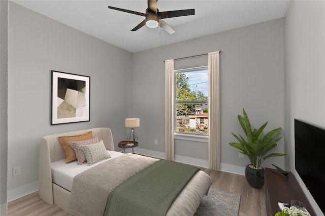 bedroom with light hardwood / wood-style flooring and ceiling fan