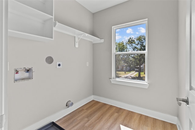 laundry area featuring hardwood / wood-style flooring, washer hookup, and electric dryer hookup