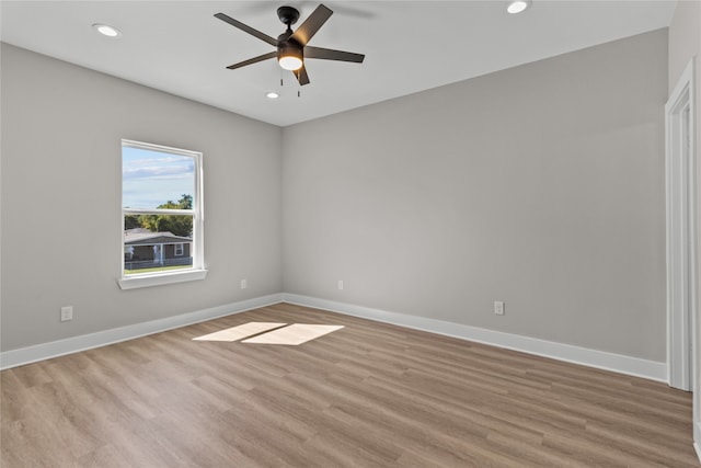 spare room featuring light wood-type flooring and ceiling fan