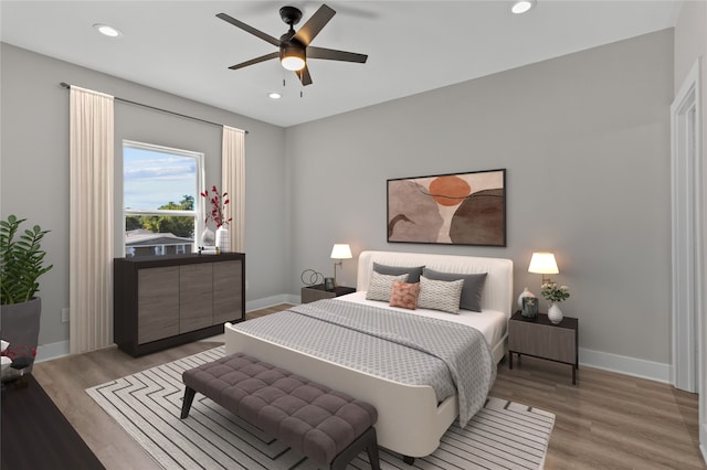 bedroom with light hardwood / wood-style floors and ceiling fan