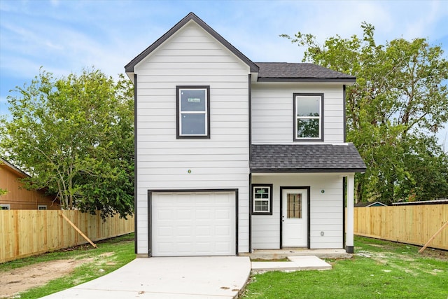 view of front of house with a front lawn and a garage