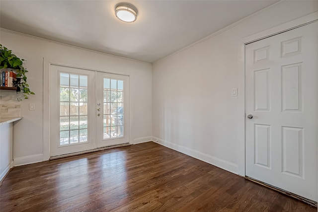 unfurnished room featuring french doors, crown molding, and dark hardwood / wood-style flooring