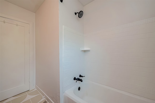 bathroom with tiled shower / bath combo and tile patterned flooring