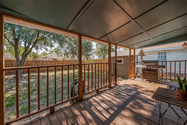 wooden deck with a yard and grilling area