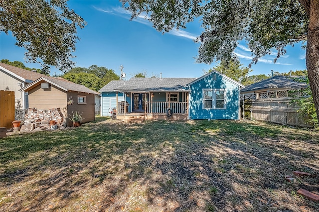 back of property featuring a lawn and a porch