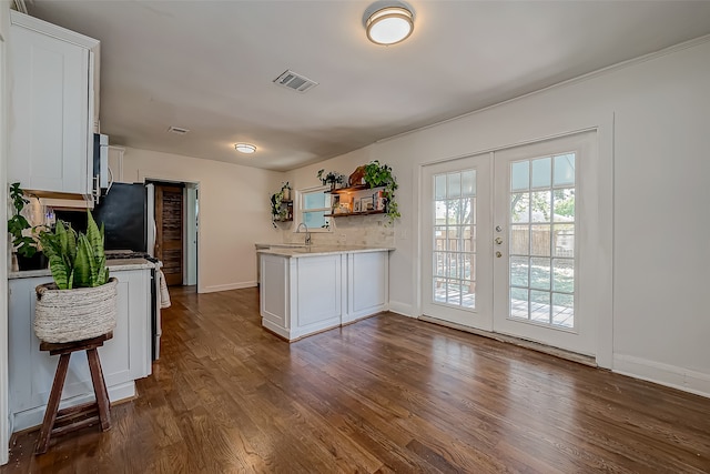 kitchen with sink, french doors, kitchen peninsula, white cabinetry, and dark hardwood / wood-style floors