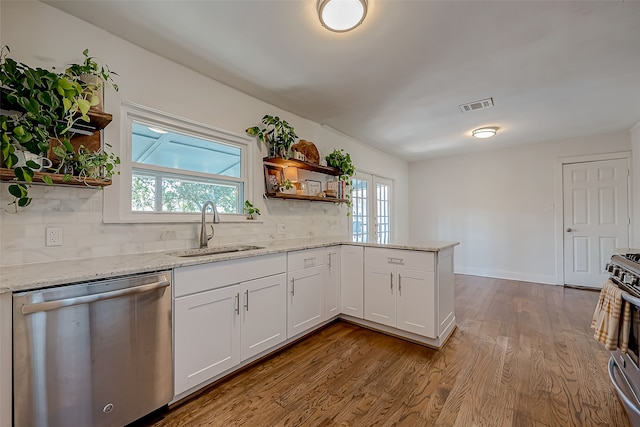 kitchen featuring stainless steel appliances, sink, a wealth of natural light, and white cabinets