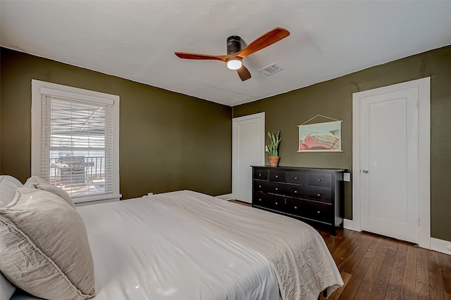 bedroom with ceiling fan and dark hardwood / wood-style flooring