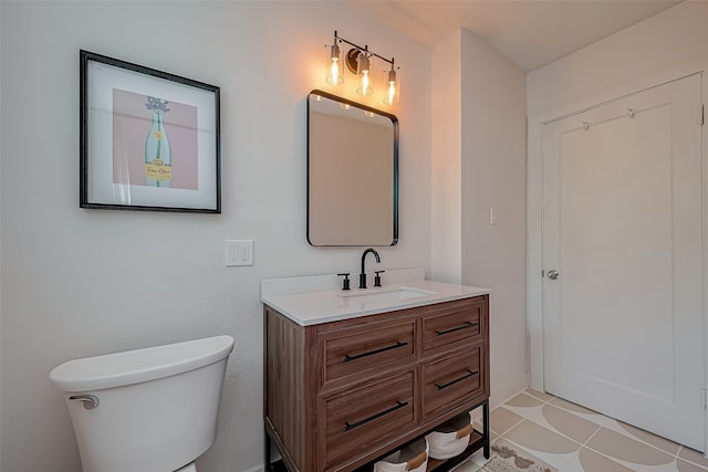 bathroom featuring vanity, toilet, and tile patterned flooring