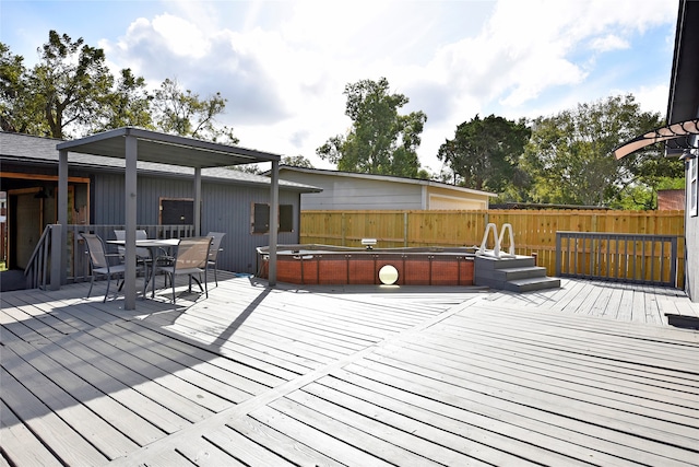 wooden terrace with a hot tub