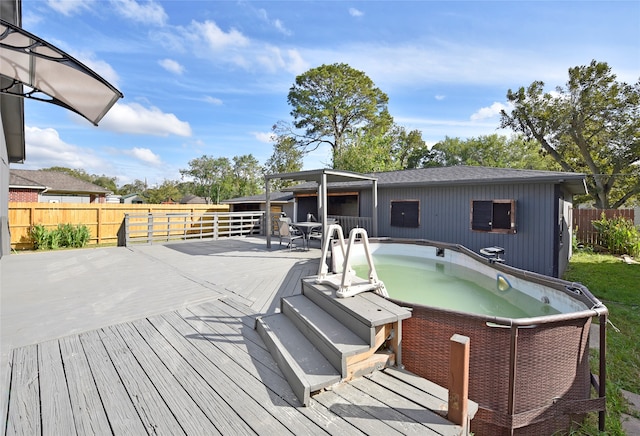 wooden terrace with a hot tub