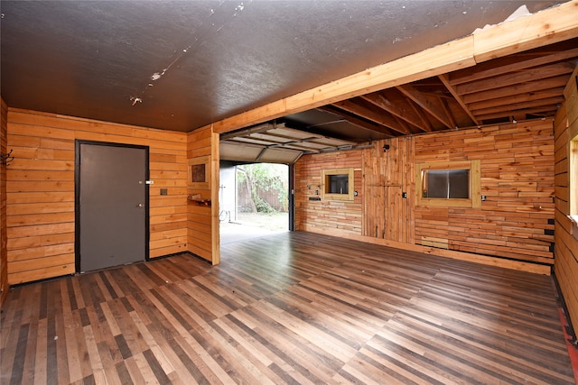 interior space featuring dark hardwood / wood-style floors and wood walls