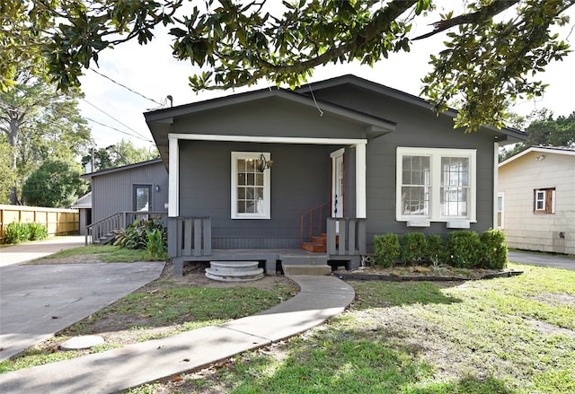 bungalow-style home featuring a porch and a front lawn