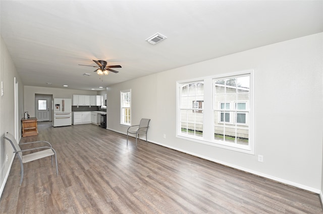 unfurnished living room featuring light hardwood / wood-style flooring and ceiling fan