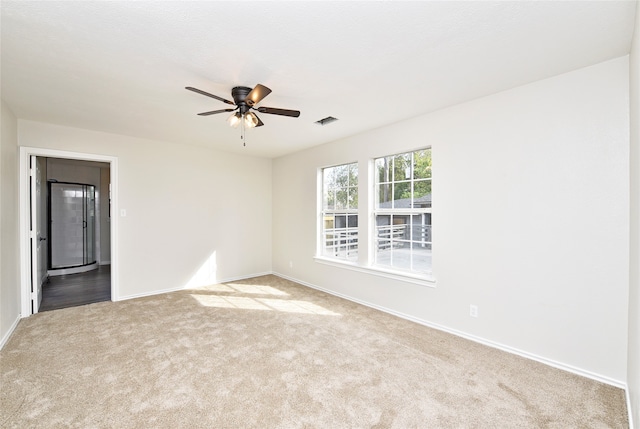 unfurnished room featuring light carpet and ceiling fan