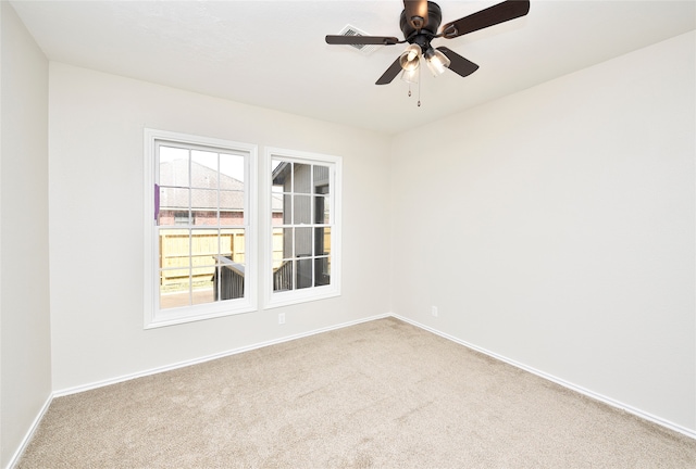 empty room featuring light carpet and ceiling fan