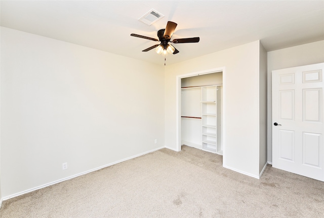 unfurnished bedroom featuring light carpet, a closet, and ceiling fan