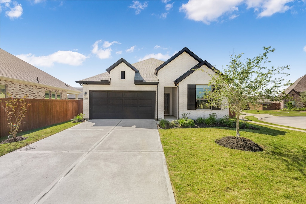 view of front facade with a front yard and a garage