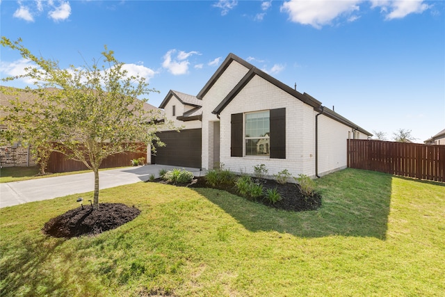 view of front of home featuring a front yard and a garage