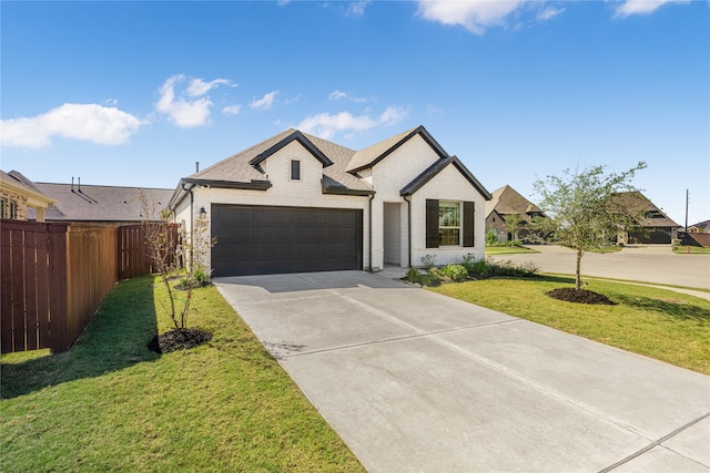 view of front of home with a front yard and a garage