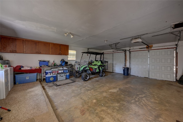 garage with washer / dryer and a garage door opener