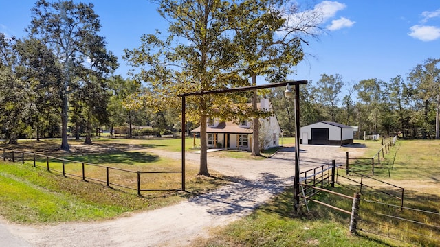 exterior space with a rural view, a lawn, and an outbuilding