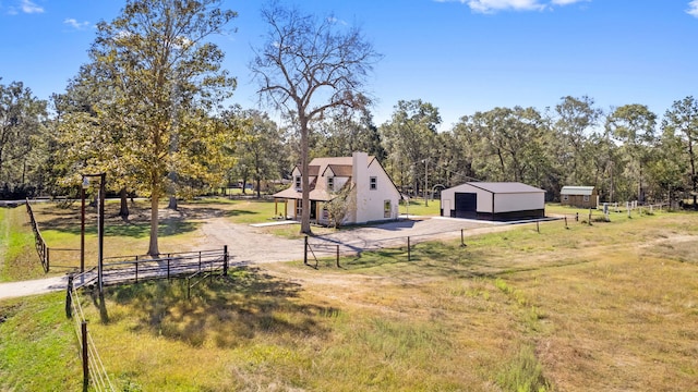 view of yard with an outdoor structure and a rural view