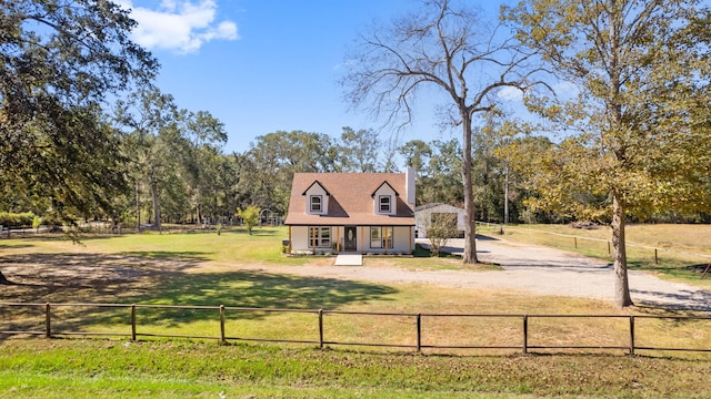 view of front facade featuring a rural view, a front lawn, and a porch