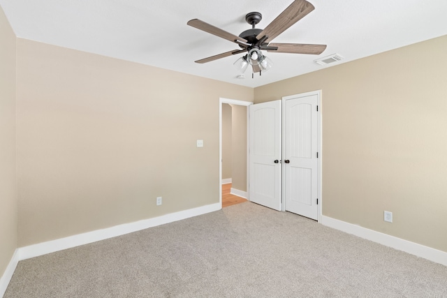 unfurnished bedroom with light carpet, a closet, and ceiling fan