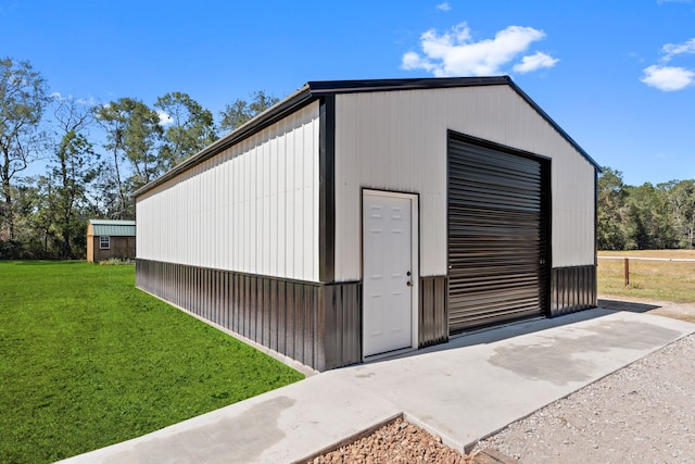 view of outbuilding featuring a yard and a garage