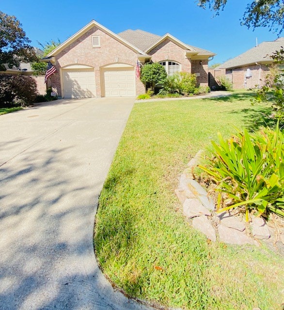 view of front of property with a front lawn and a garage