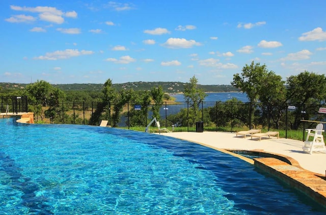 view of swimming pool with a water view