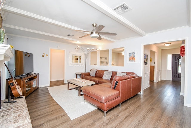 living room with ceiling fan, wood-type flooring, and ornamental molding