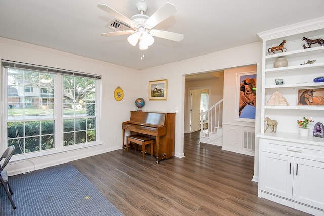 miscellaneous room featuring ceiling fan, dark hardwood / wood-style floors, and ornamental molding