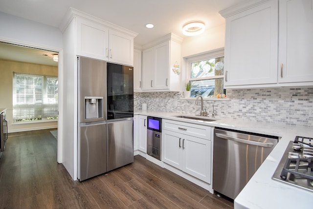 kitchen featuring a healthy amount of sunlight, white cabinetry, sink, and appliances with stainless steel finishes