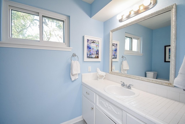 bathroom featuring vanity and toilet