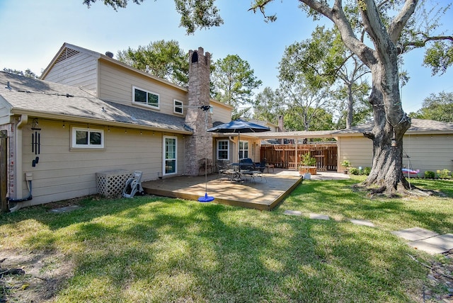 rear view of property featuring a yard