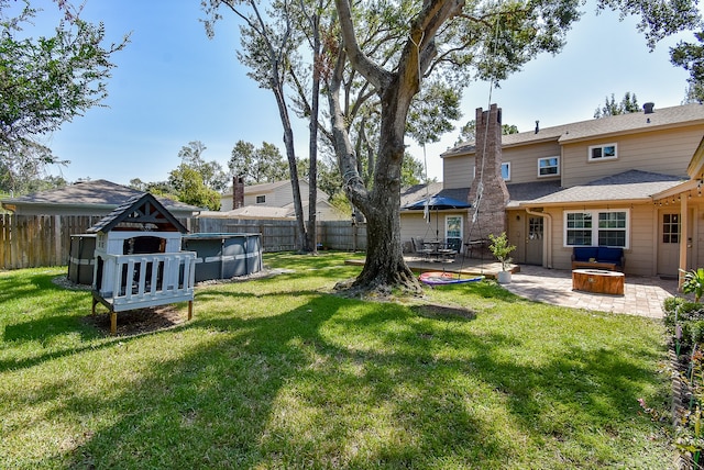 view of yard featuring a patio and a fenced in pool