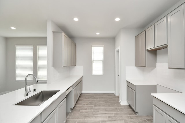 kitchen featuring light hardwood / wood-style floors, sink, and gray cabinets