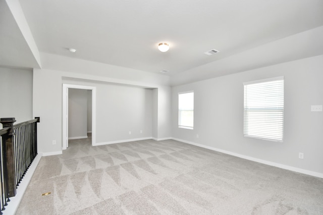 unfurnished living room with light colored carpet