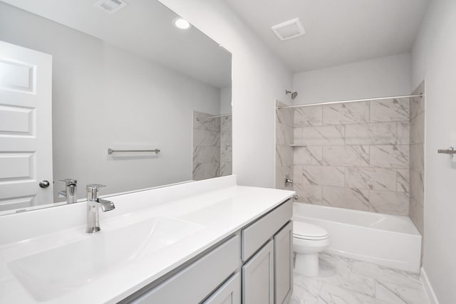 full bathroom featuring toilet, tiled shower / bath, and vanity