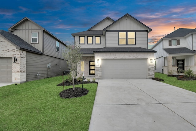 view of front facade with a yard and a garage